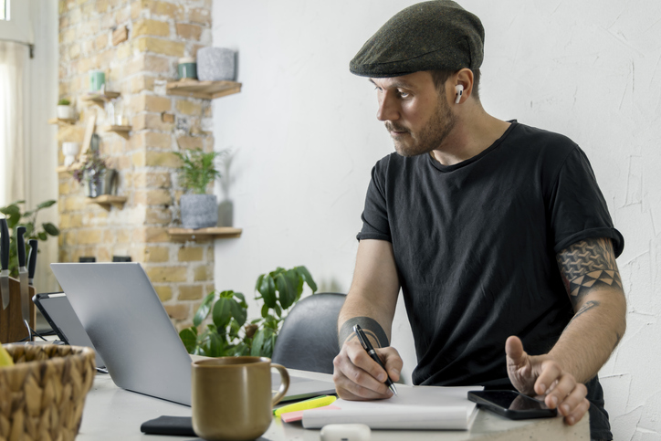 Man Working From Home Using a Laptop in a Cozy Environment